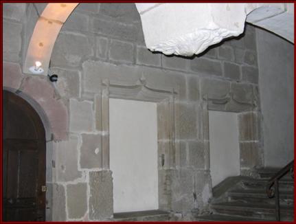 Au rez-de-chaussée du grand quartier, les fenêtres murées de l'ancien bâtiment des hôtes (XVe - XVIe siècle)